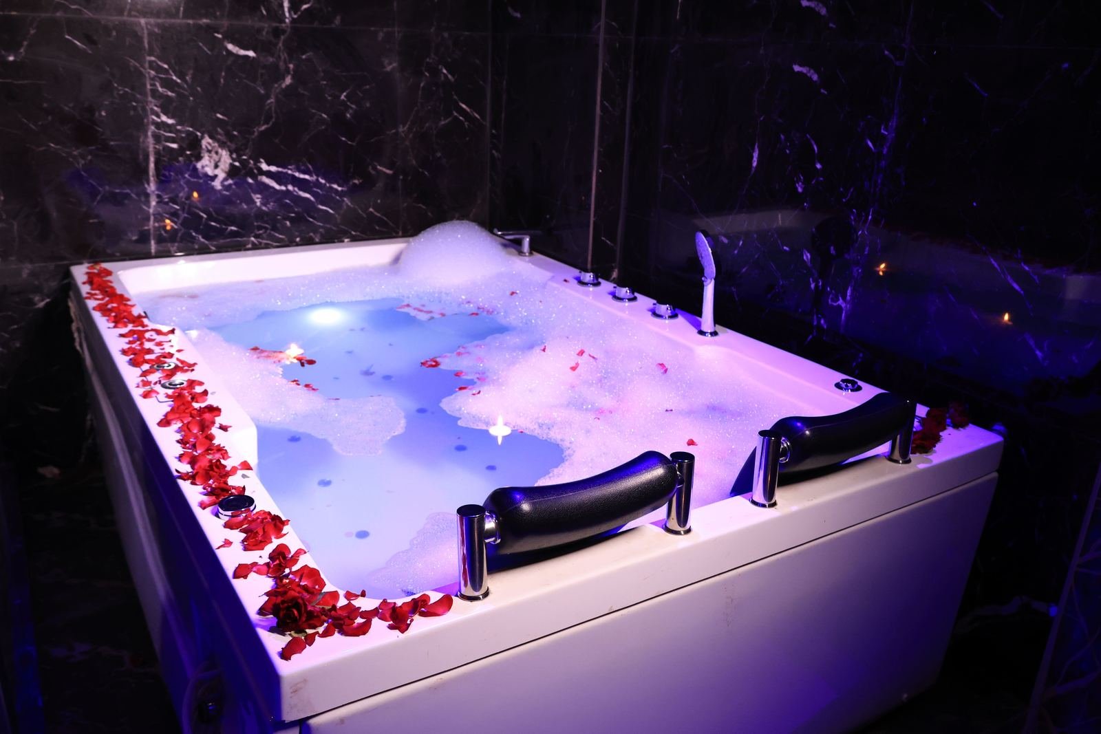Private jacuzzi suite lit with candles at Paradise Spa, Mira Road